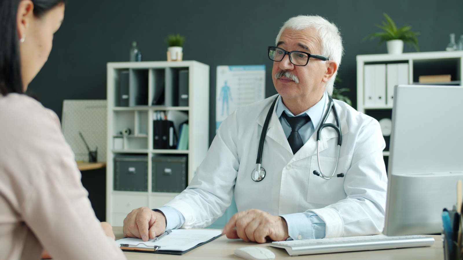 A physician consulting with a patient at PremCare Family Medical Center