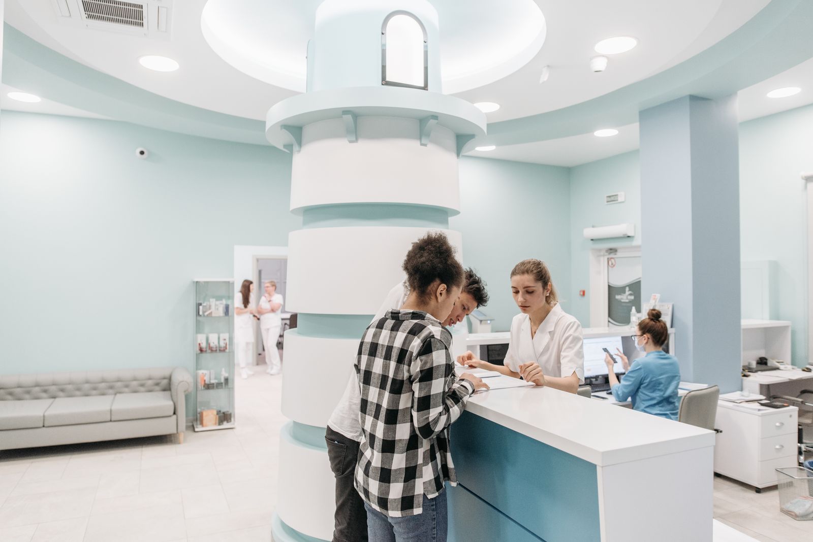 A staff member welcoming a patient at the PremCare front desk